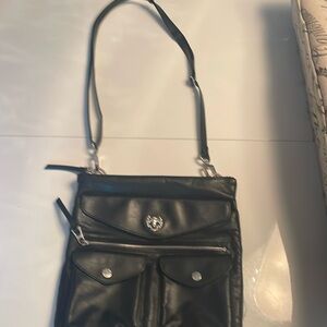 Black leather Rudsak bag . 7 pockets and an internal flashlight .